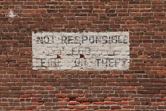 Disclaimer painted on brick wall