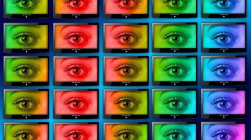 control wall with monitors displaying an eye in different colors