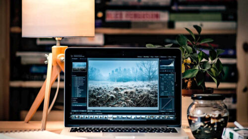 laptop on desk displays image