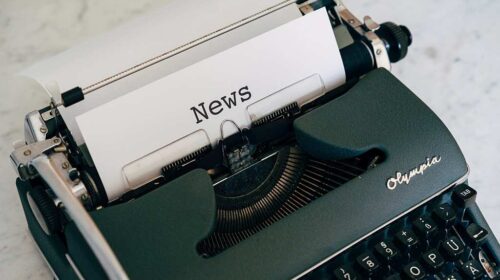 typewriter with paper has title news